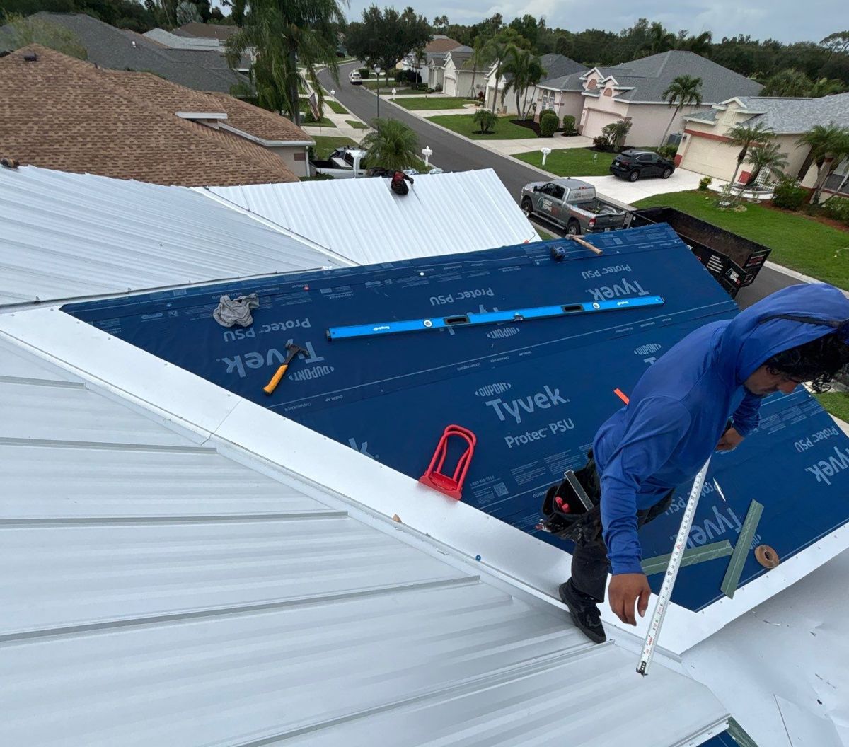 Legacy Roofing crew installing standing seam metal panels