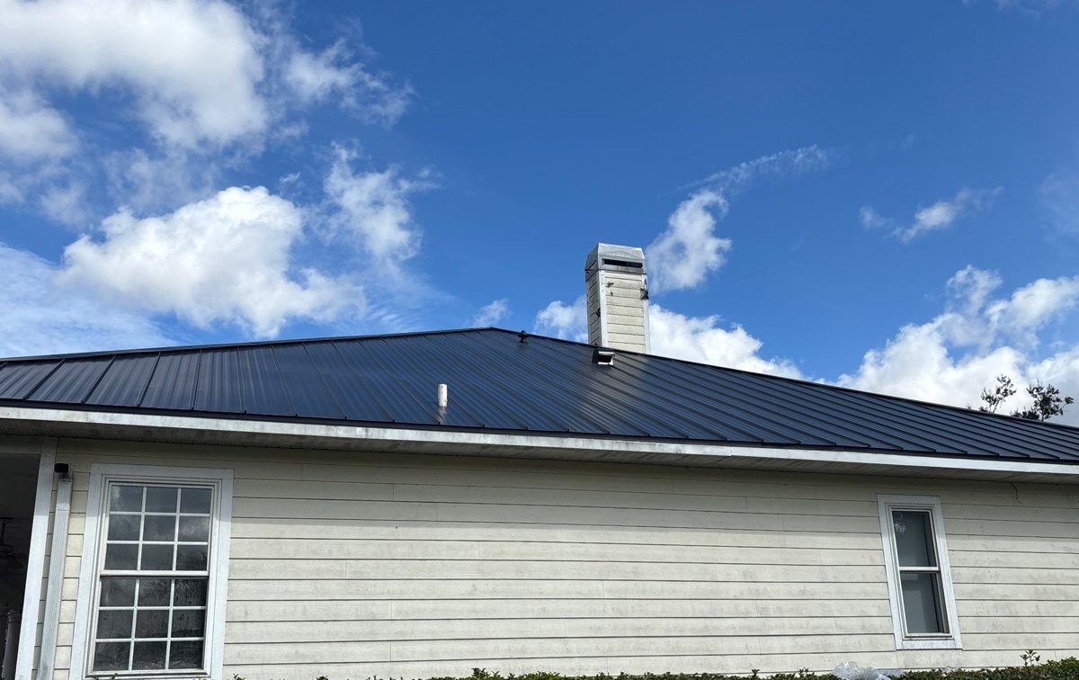 Finished charcoal standing seam metal roof on a lakefront home
