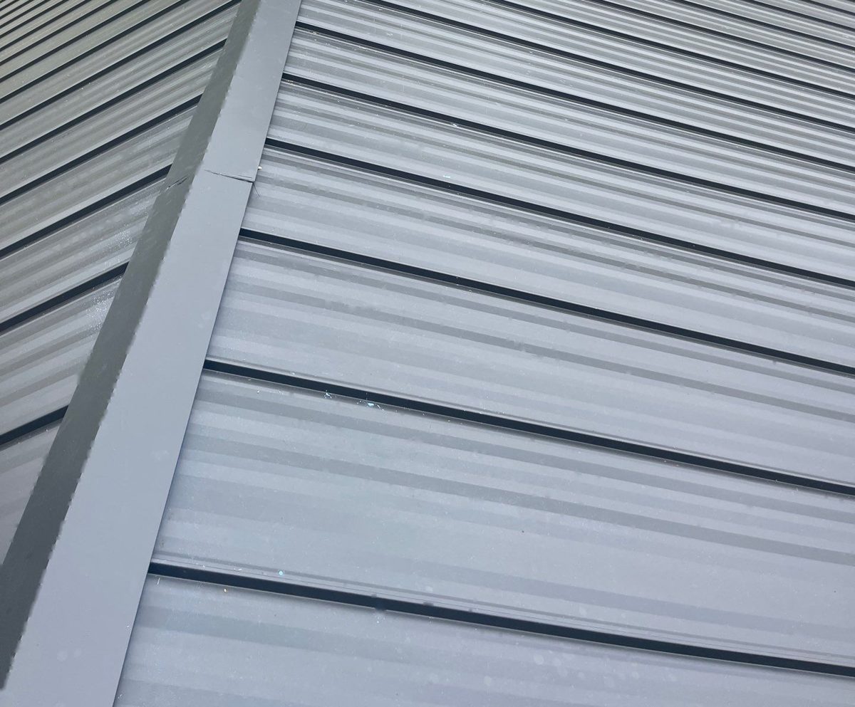 Close-up of gray striated standing seam metal roof panels